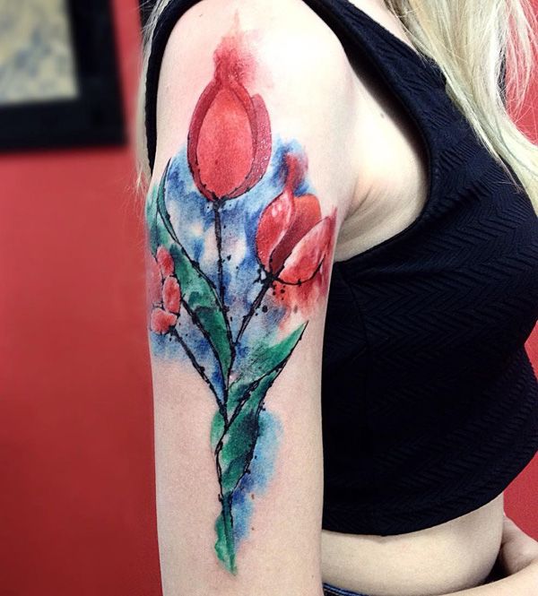 Color tattoo of a tulip on the shoulder for women