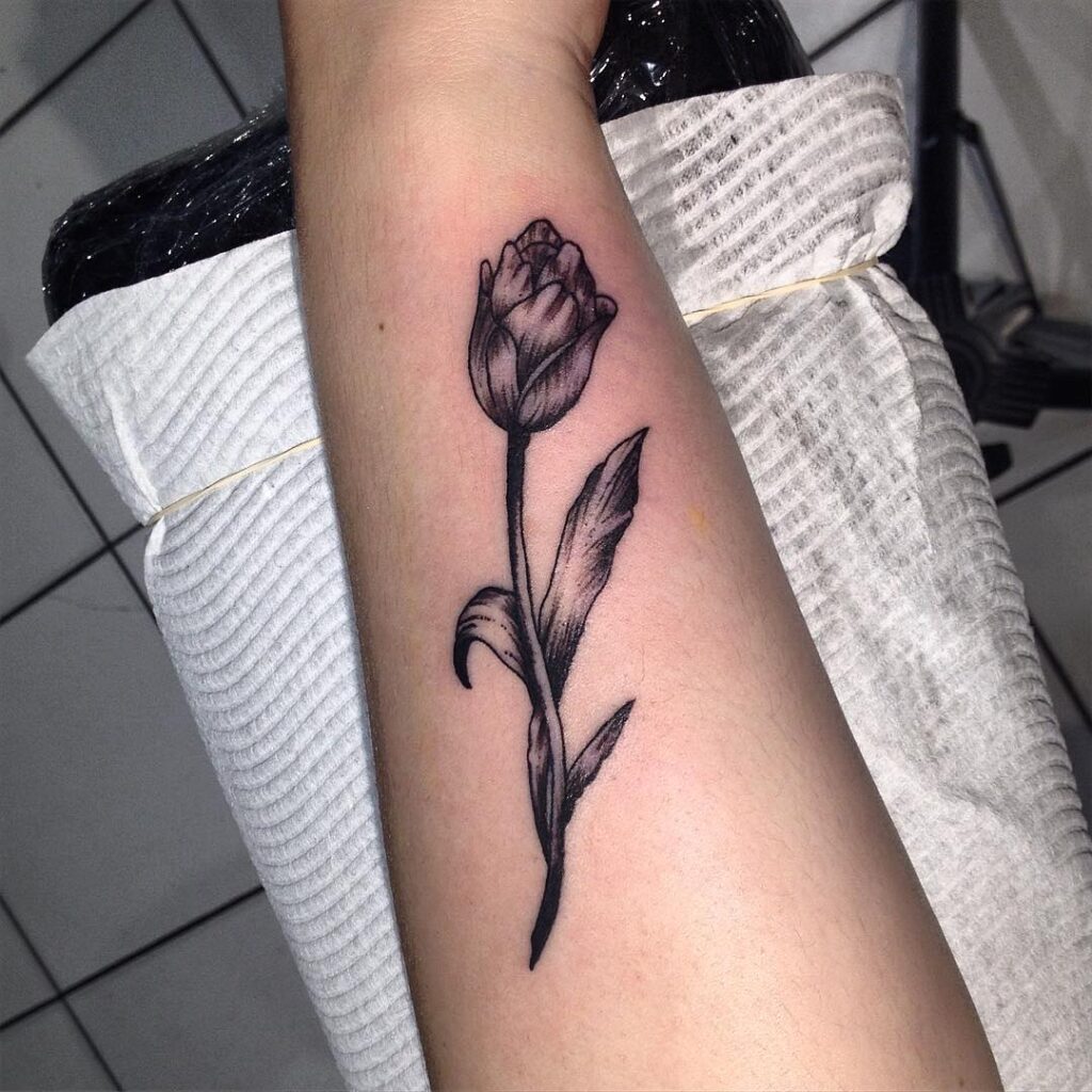 Tulip tattoo on the forearm for women