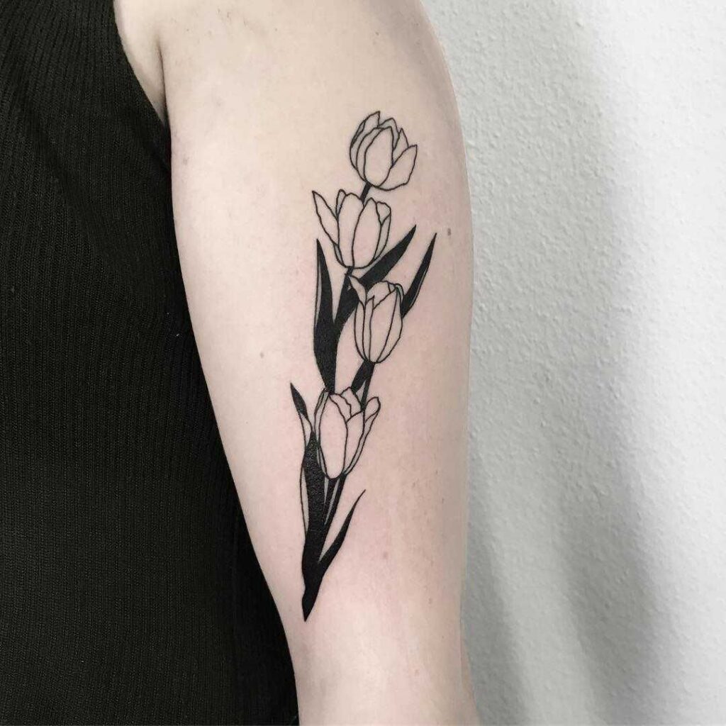 Large tulip tattoo on the shoulder for women