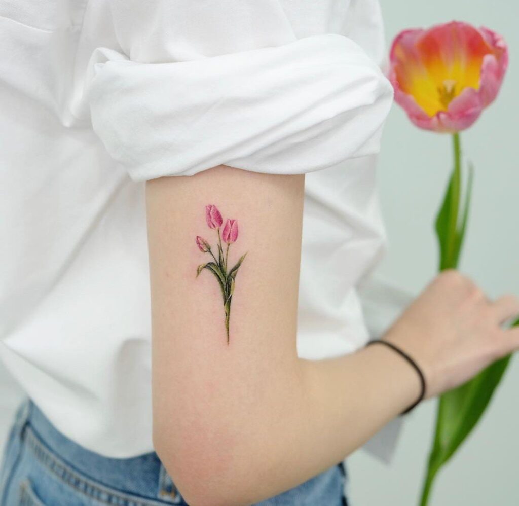 Color tattoo of a tulip on the shoulder for women