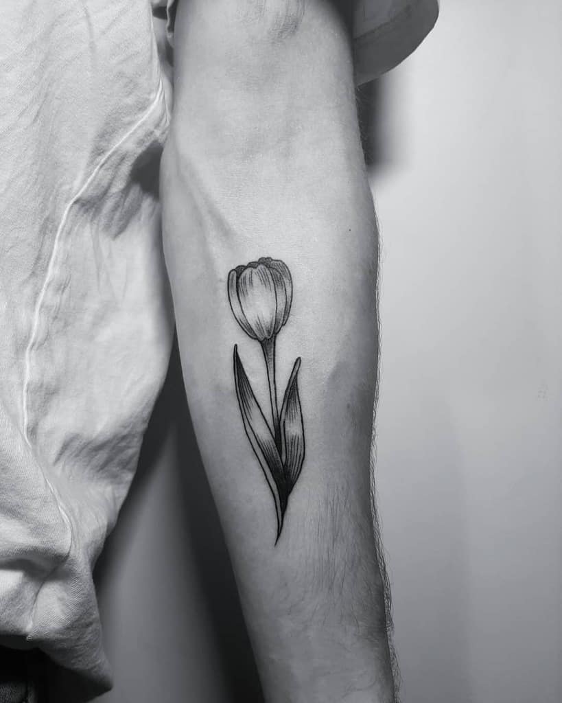 Large tulip tattoo on the forearm for men