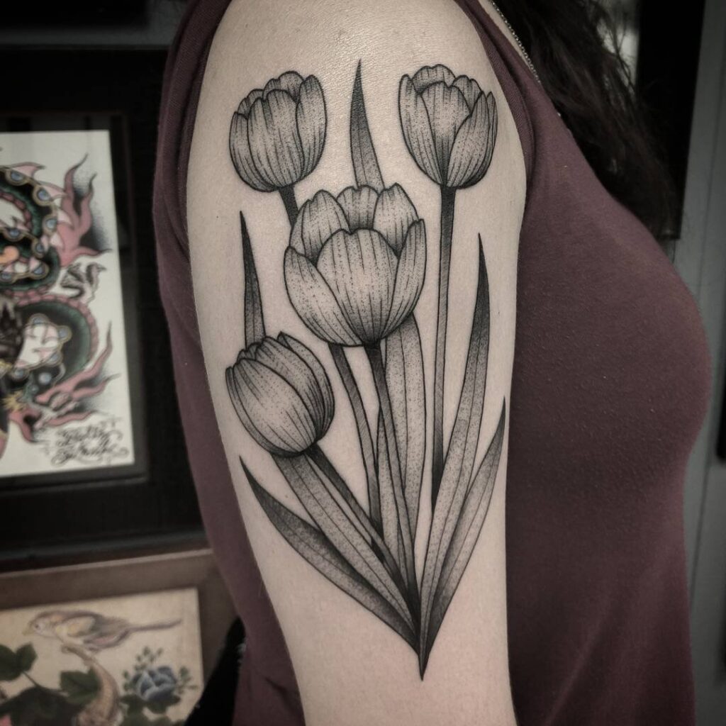 Large tulip tattoo on the shoulder for women