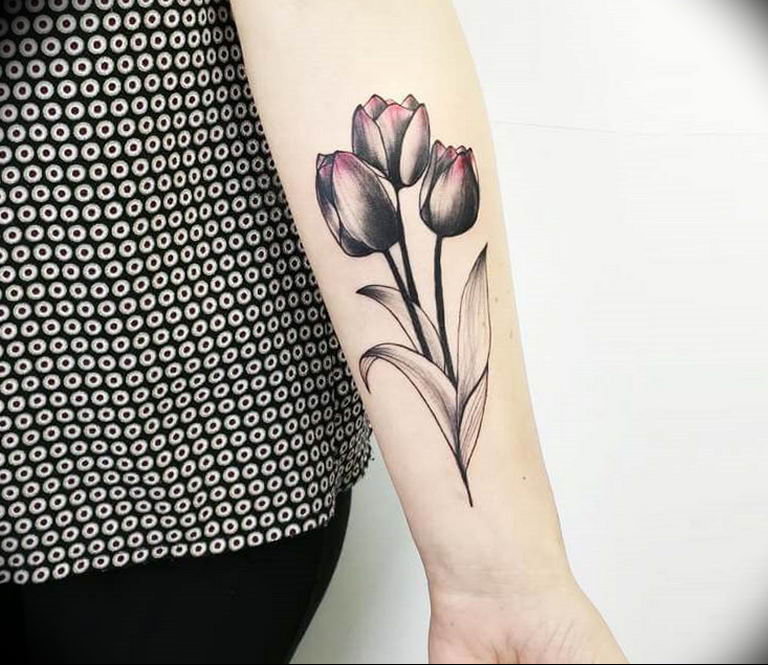 Tulip tattoo on the forearm for women