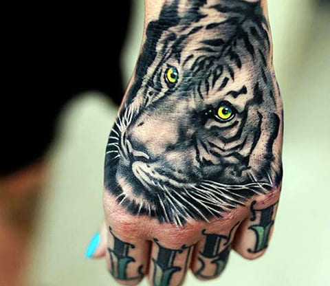 Tattoo of a tiger on the hand for women