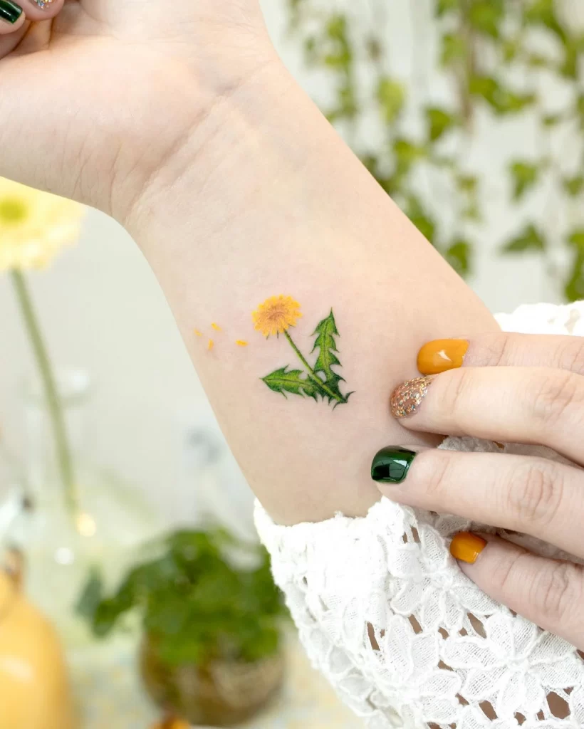 Color dandelion tattoo on forearm for women