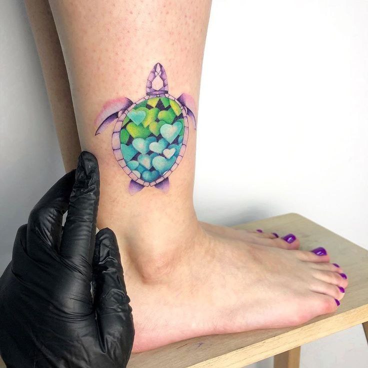 Tattoo of a colored turtle on the shin for women