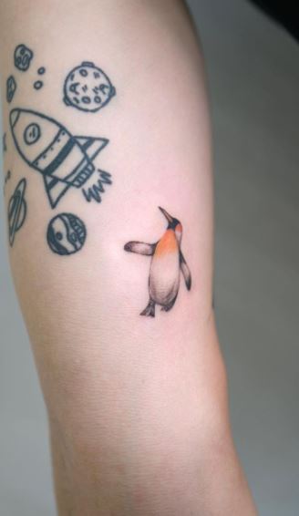 Penguin tattoo on the shoulder for women