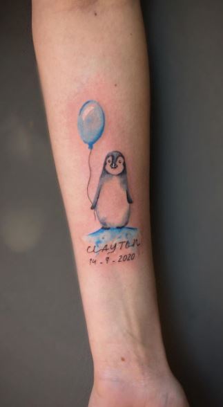 Penguin tattoo on the forearm for women