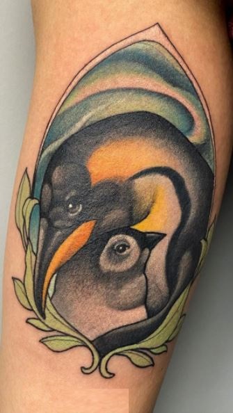 Tattoo of a penguin on the shoulder for men