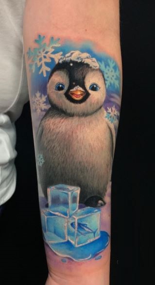 Penguin tattoo on the forearm for women