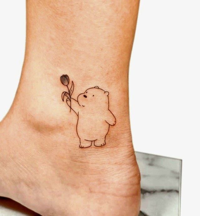 Tattoo of a bear with a tulip on the ankle for women