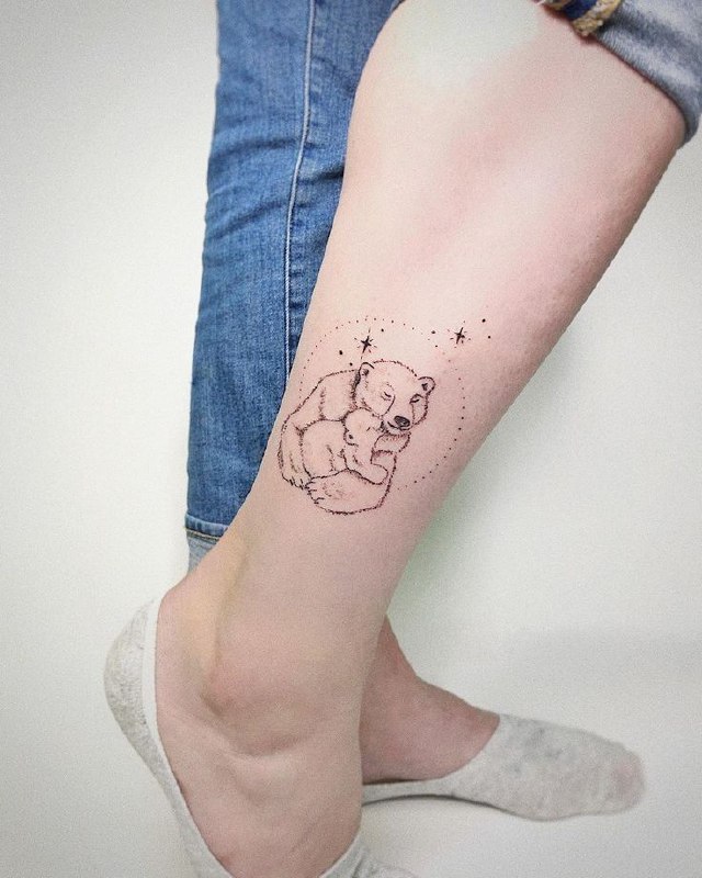 Tattoo of two bears on the shin for women