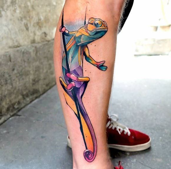 Tattoo of a colored chameleon on the shin for women