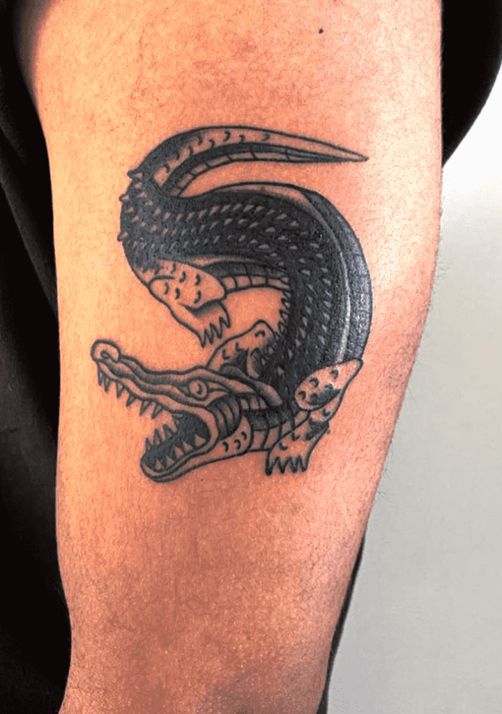 Tattoo of a crocodile on the shoulder for men