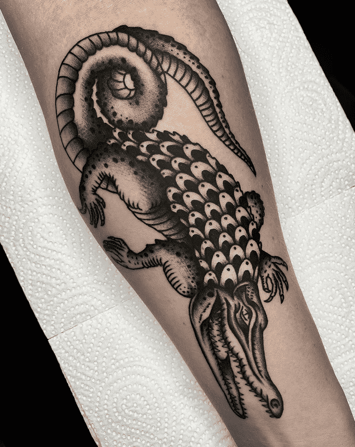 Tattoo of a crocodile on the forearm for men