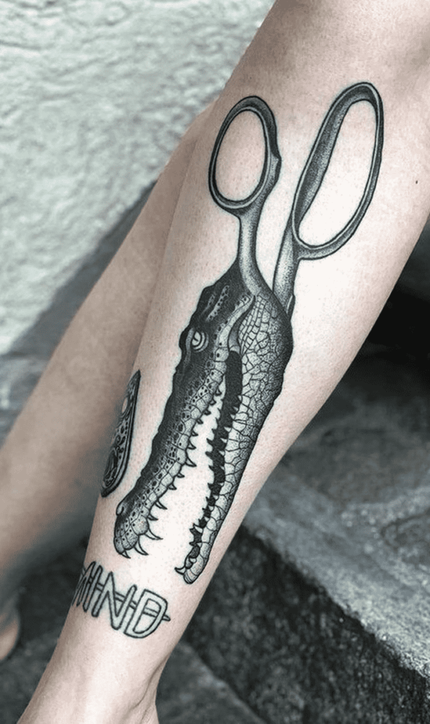 Crocodile tattoo on the shin for women