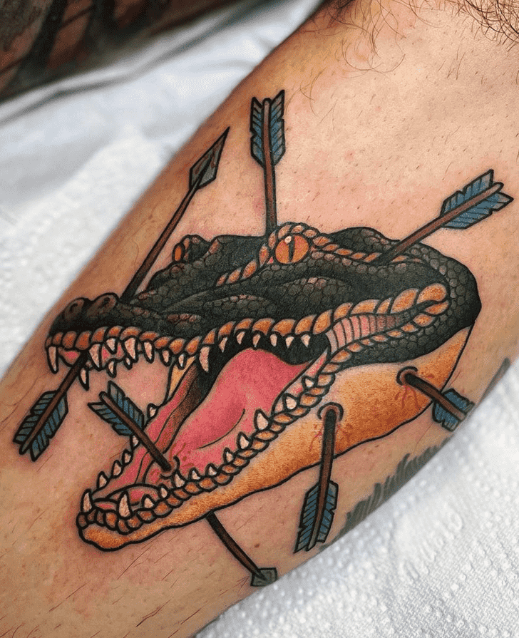 Tattoo of a crocodile with arrows on the leg for men