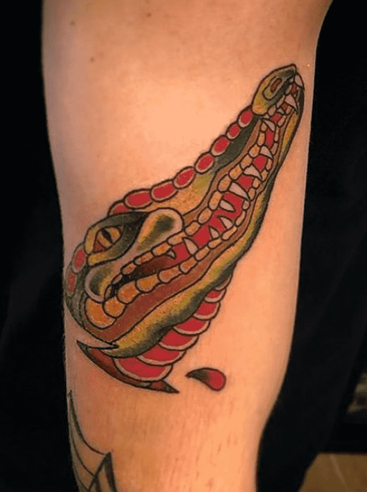 Tattoo of a colored crocodile on the shin for men