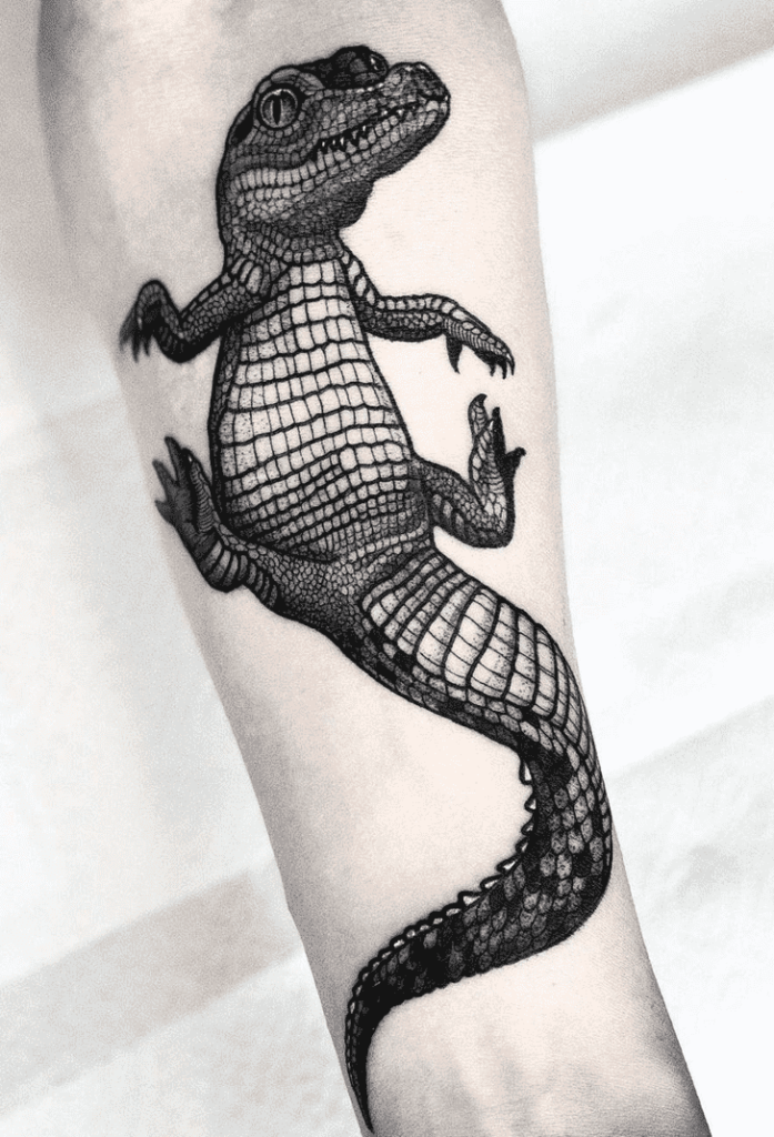 Tattoo of a crocodile on the forearm for men