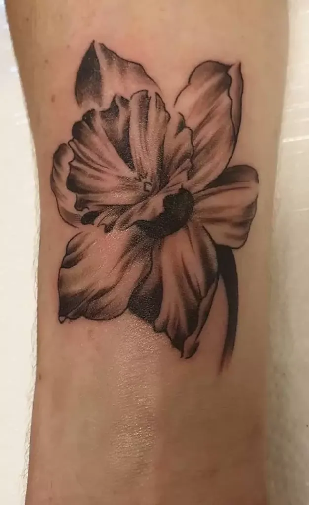 Large daffodil flower tattoo on the arm for men