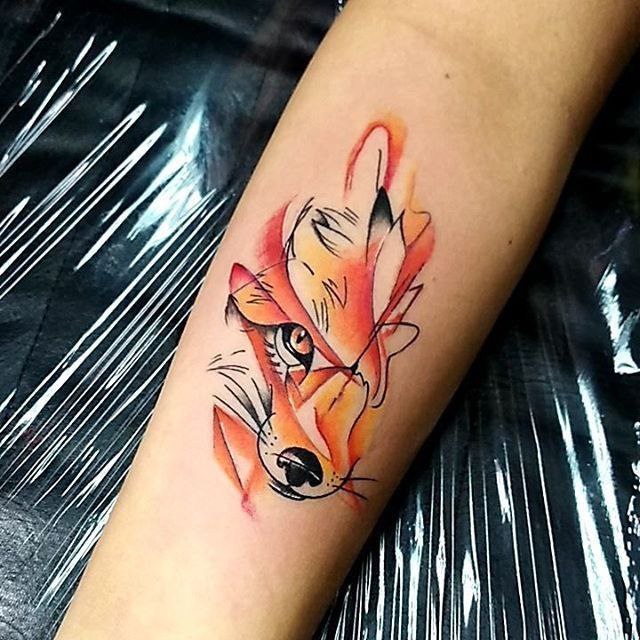 Tattoo of a colored fox on the forearm for women