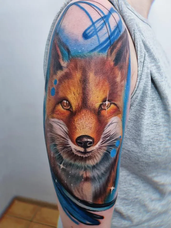 Tattoo of a colored fox on the shoulder for women