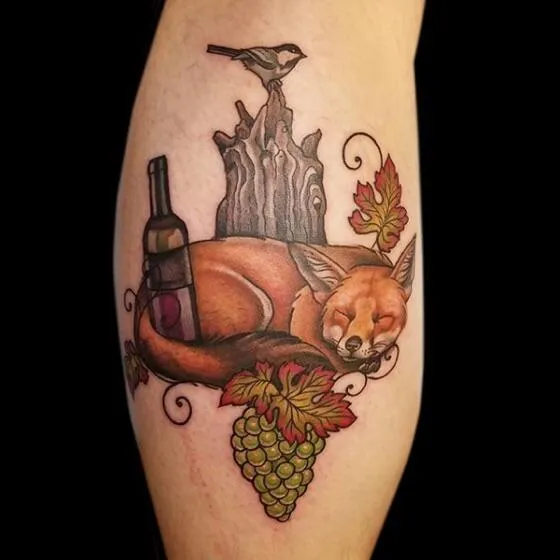 Tattoo of a colored fox on a calf for women