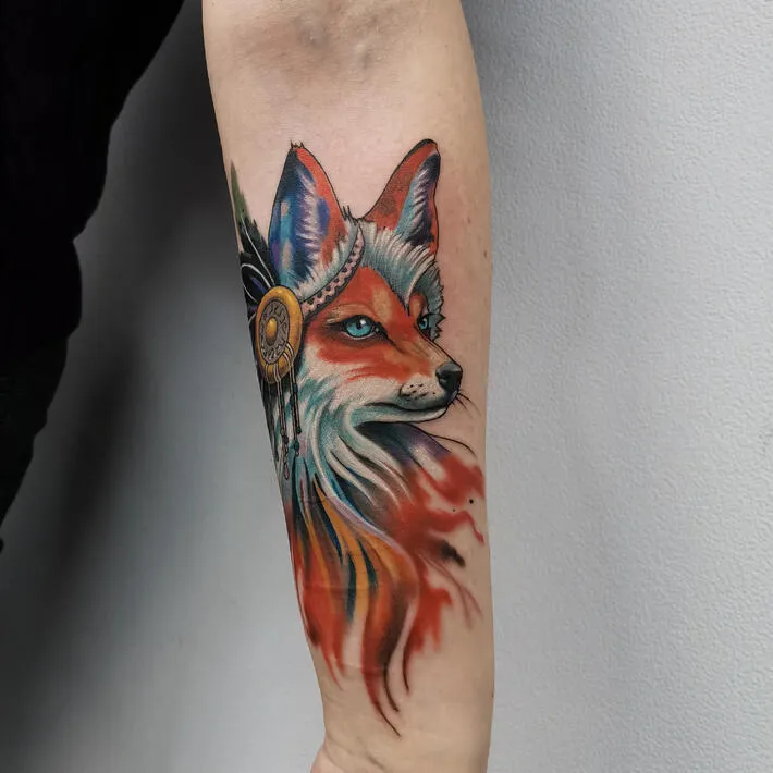 Tattoo of a colored fox on the forearm for women