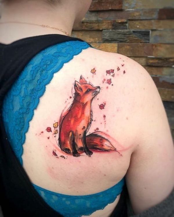 Tattoo of a colored fox on the shoulder blade for women