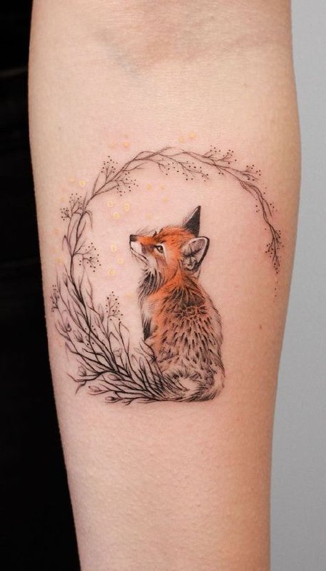 Tattoo of a colored fox on the forearm for women