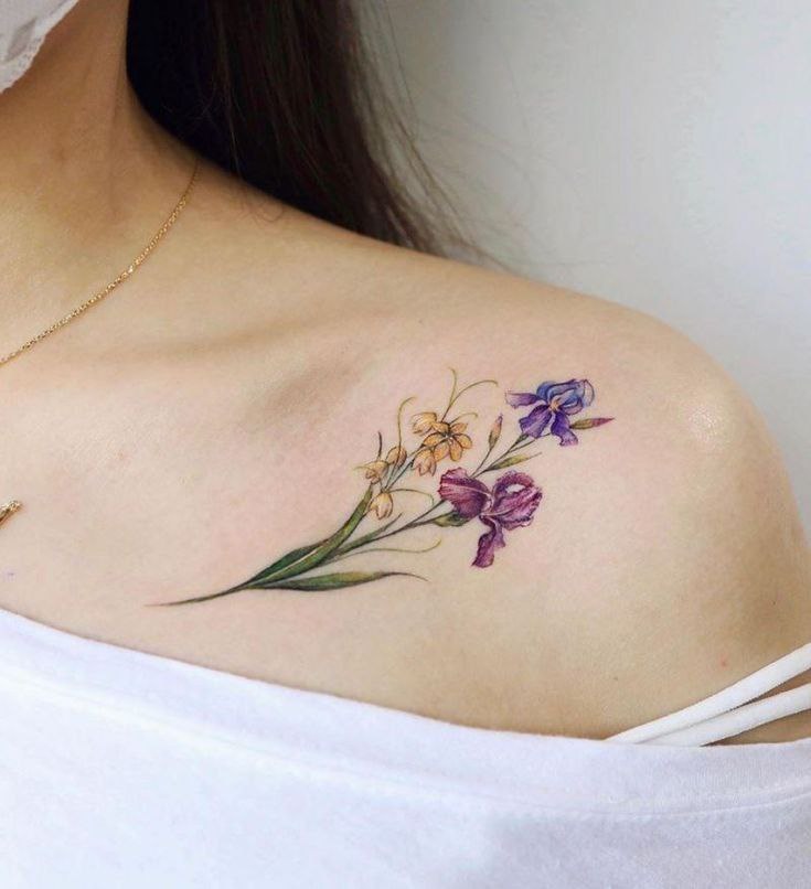Color iris tattoo on the collarbone for women Color iris tattoo on the collarbone for women