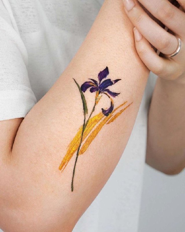 Color iris tattoo on the forearm for women