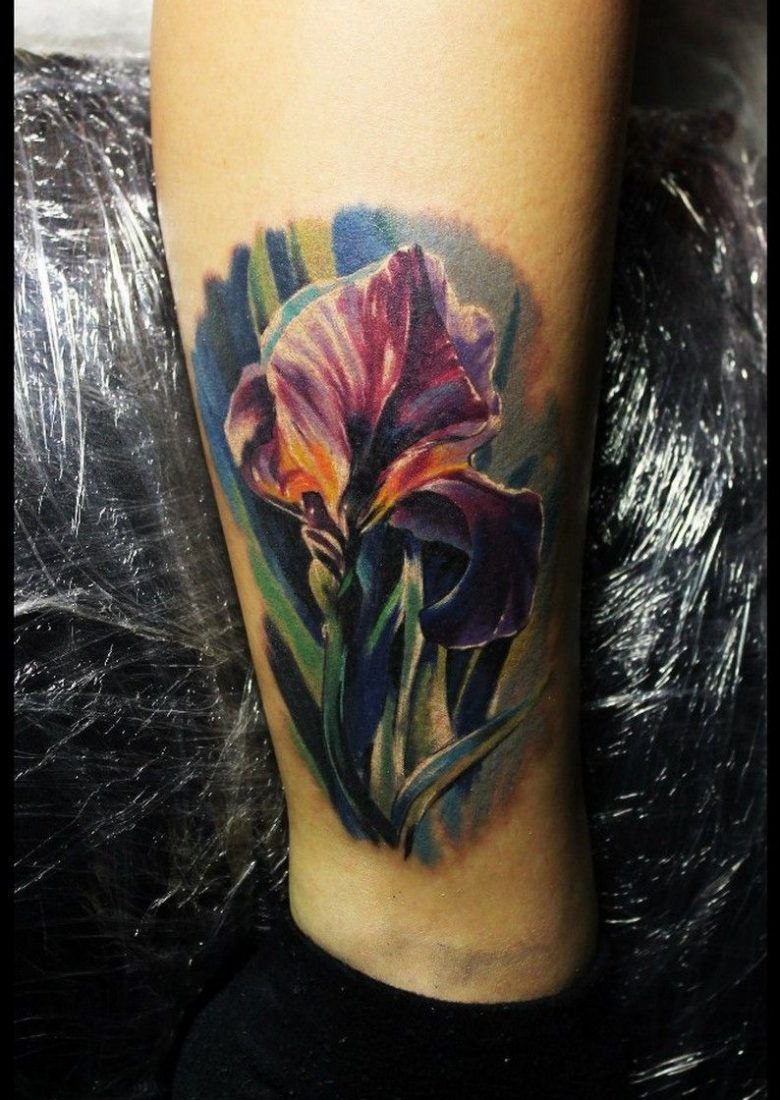 Color iris tattoo on the shin for men