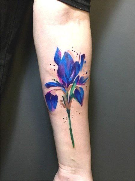 Color iris tattoo on the forearm for men