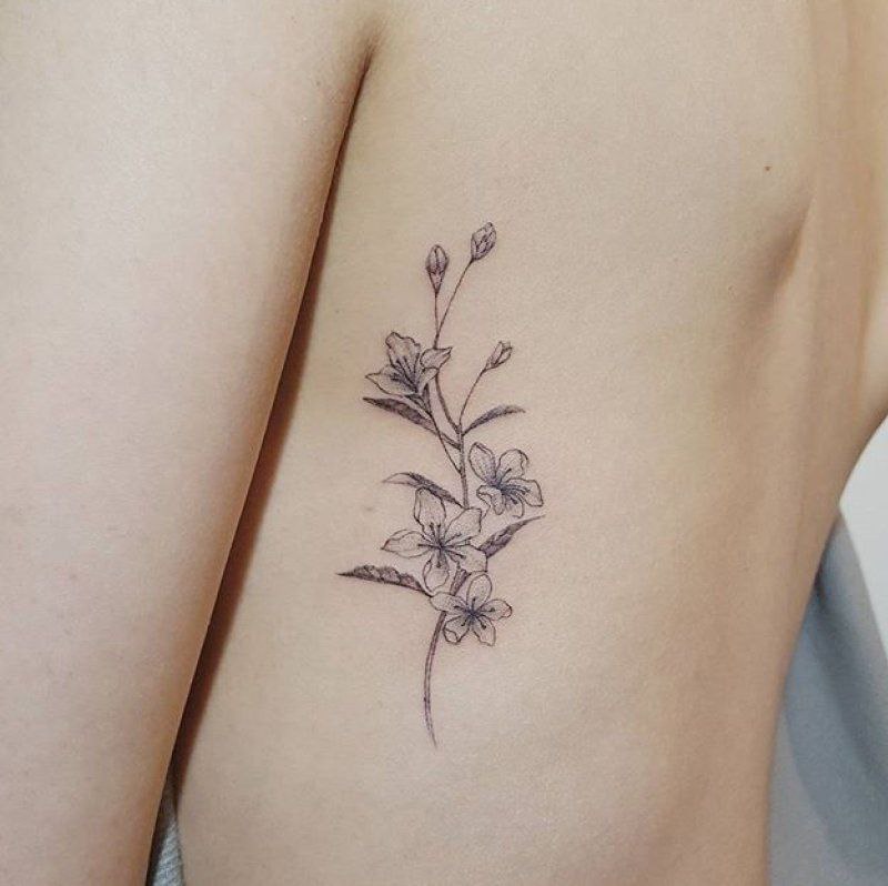 Jasmine tattoo on the side for women