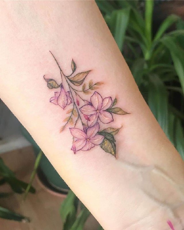 Colorful jasmine tattoo on the forearm for women