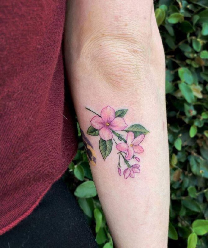 Colorful jasmine tattoo on the forearm for women