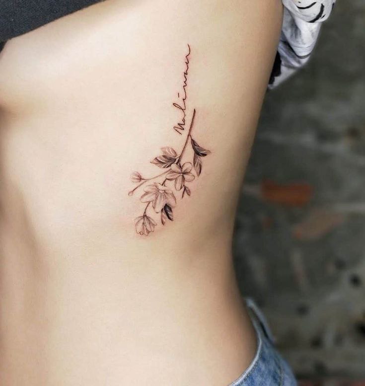 Jasmine tattoo on the side for women