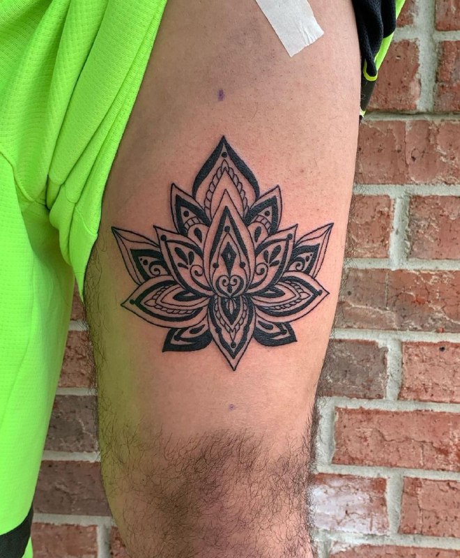 Large lotus tattoo on the thigh for men