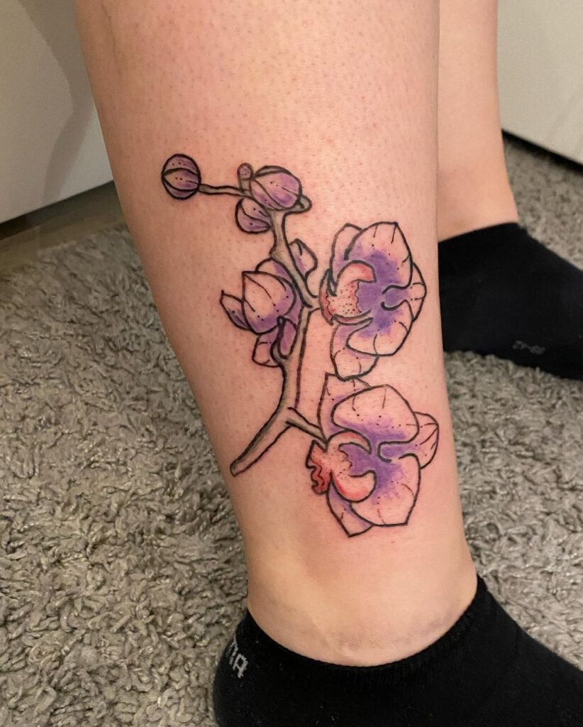 Color orchid tattoo on the shin for women