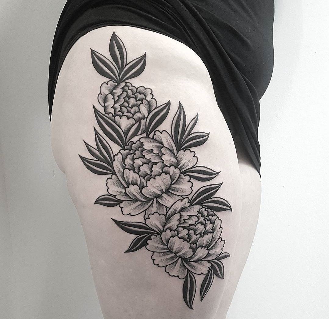 Large peony tattoo on the thigh for women