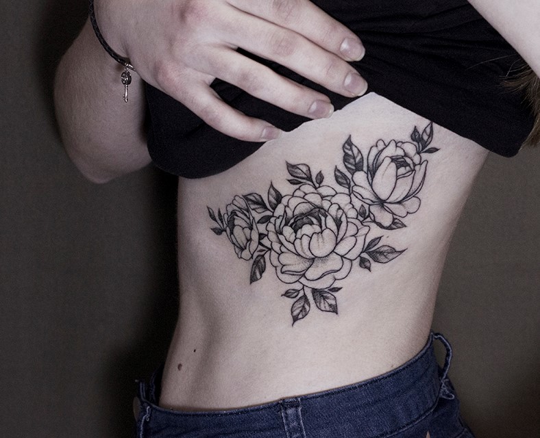 Large peony tattoo on the side for women