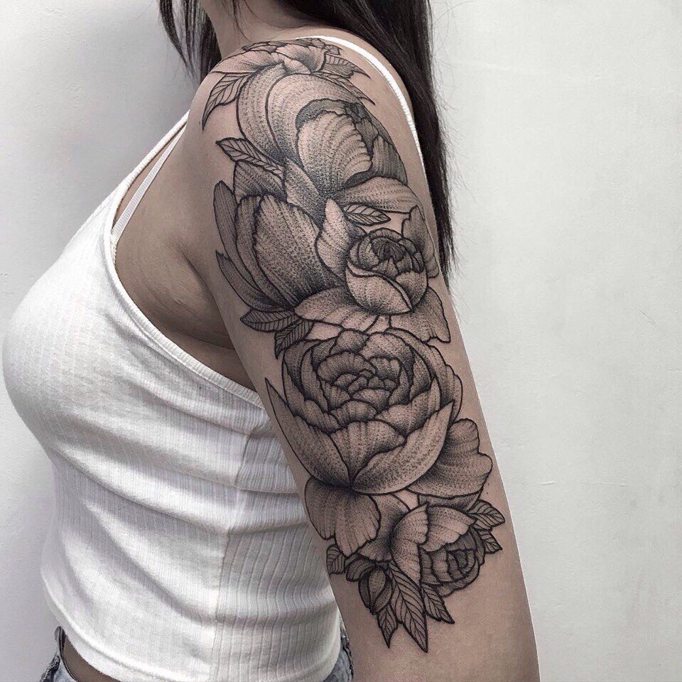 Large peony tattoo on the arm for women