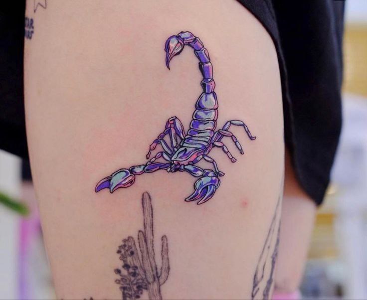 Color tattoo of a scorpion on the thigh for women