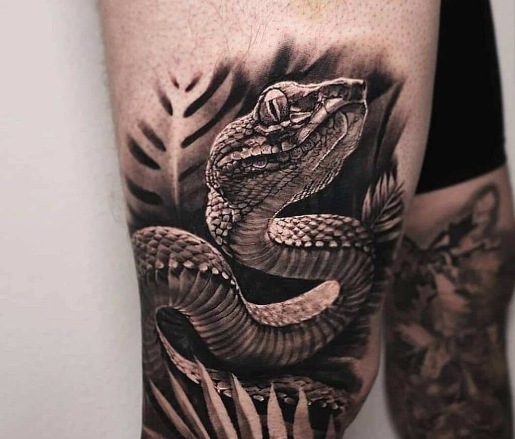 Snake tattoo on the thigh for men