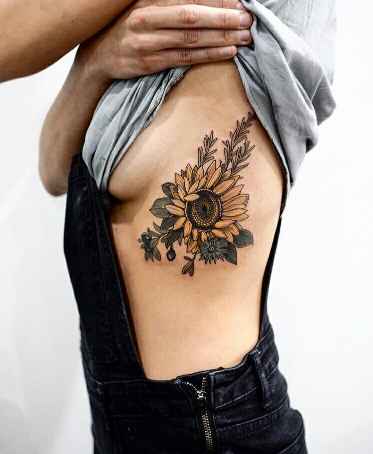 Large sunflower tattoo on the side for women