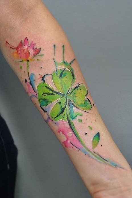 Colored clover tattoo on the forearm for women