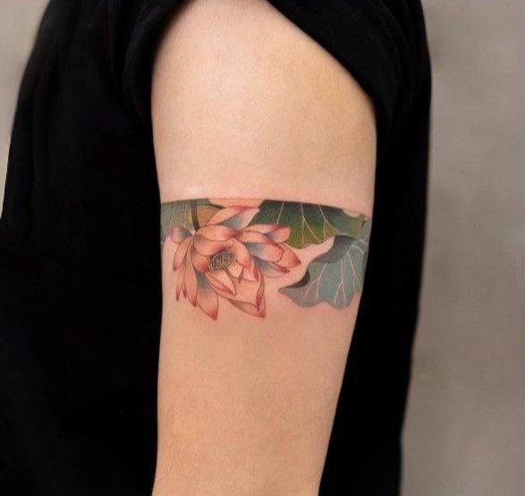 Colored lotus tattoo on the shoulder for men