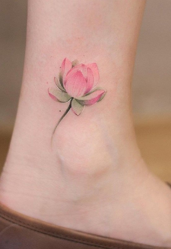 Colored lotus tattoo on the shin for women