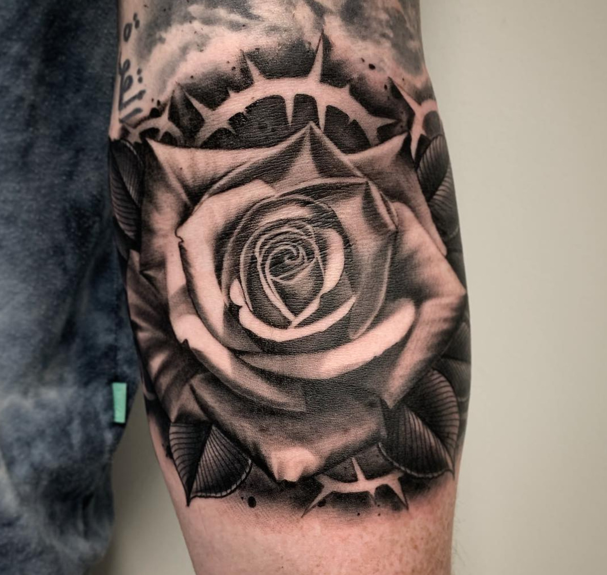 Large rose tattoo on the arm for men